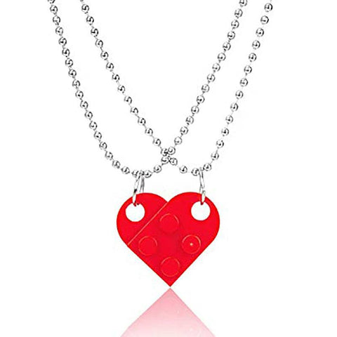 Red heart-shaped acrylic necklace with a silver chain, featuring a playful and romantic design.