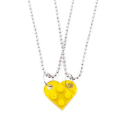 Yellow heart-shaped acrylic necklace with a silver chain, a cheerful and unique couple's jewelry option.