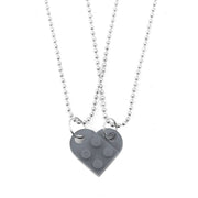 Gray heart-shaped acrylic necklace with a silver chain, a subtle and elegant couple's jewelry piece.