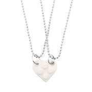 White heart-shaped acrylic necklace with a silver chain, a minimalist and stylish Valentine's Day accessory.