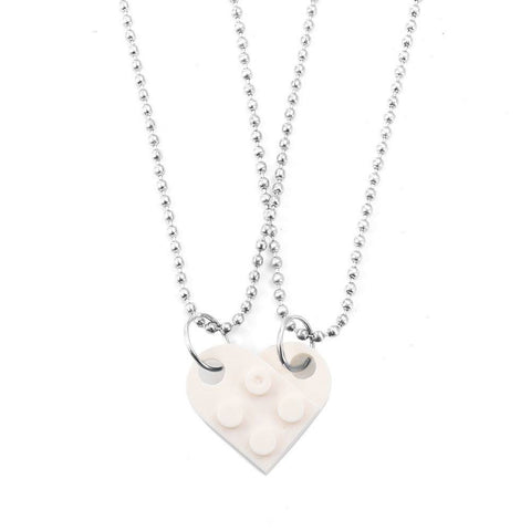 White heart-shaped acrylic necklace with a silver chain, a minimalist and stylish Valentine's Day accessory.